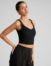 black ribbed cropped tank with a front and back v neckline.