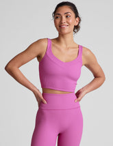 pink ribbed cropped tank top with a soft V neckline front and back, an overlapping front neckline detail, and a lining shelf bra.
