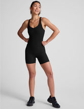 black racerback 5" inseam tank jumpsuit with a front V neckline with overlapping detail.