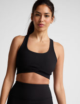 black ribbed racerback bra with overlapping hemband detail and a scoop neckline.