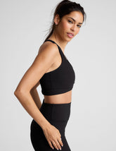 black ribbed racerback bra with overlapping hemband detail and a scoop neckline.