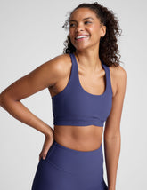 blue ribbed racerback bra with overlapping hemband detail and a scoop neckline.