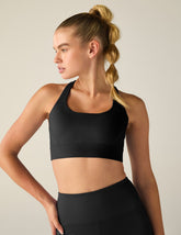 black scoop neck bra with crossover back detail.