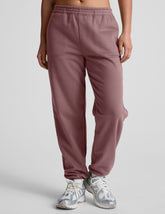 pink sweatpants with pockets and a drawstring at waistband.