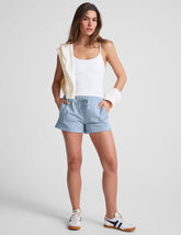 blue mid rise sweat shorts with a 3.5" inseam and pockets.