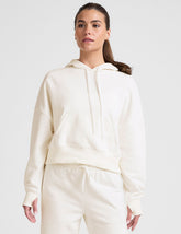 white cropped pullover with a hood with drawcord and a kangaroo pocket.