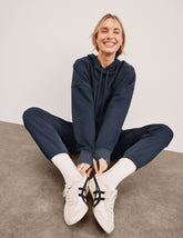 blue cropped pullover with a hood with drawcord and a kangaroo pocket.