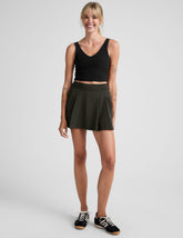 green mini pleated skirt with built-in shorts with pockets.