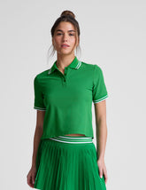 green fitted polo style short sleeve t-shirt with a front placket with buttons and side slits.
