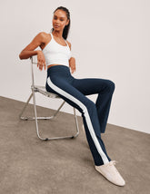 blue high-waisted bootcut pants with white contrast trim on the sides.
