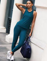 blue high-waisted midi length leggings with side pockets.