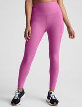 pink high-waisted midi length leggings with side pockets.