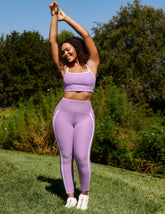 purple cropped tank with princess seams and white piping along edges.