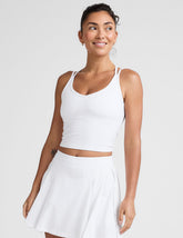 white waist length, V neckline tank top with a self shelf bra and criss-cross strap back detail.