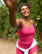 pink waist length tank top with adjustable straps.