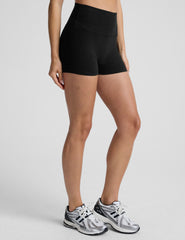 person wearing black 3" biker shorts on a plain background.
