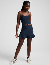 blue high-waisted skirt with a ruffle hem and built-in shorts with pockets.