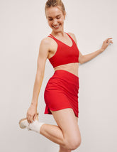 red mini athletic skirt with built-in shorts with pockets.