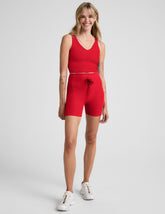 red high-waisted 5" biker shorts with pockets and a drawstring at waistband.