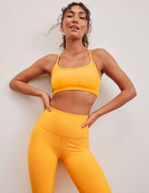 orange racerback bra with slim straps.