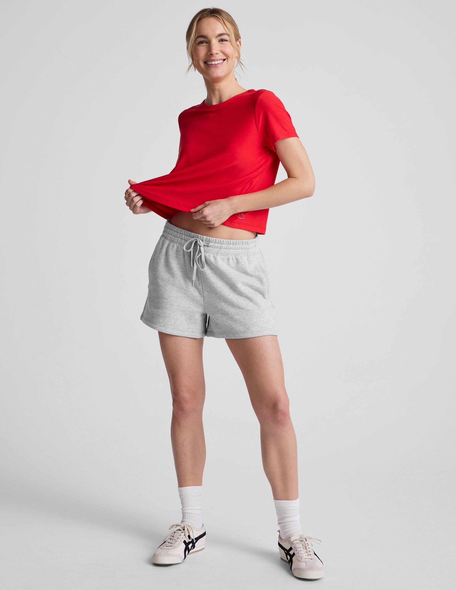 red cropped loose-fitting t-shirt with a scooped neckline.