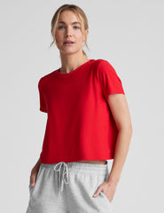 red cropped loose-fitting t-shirt with a scooped neckline.