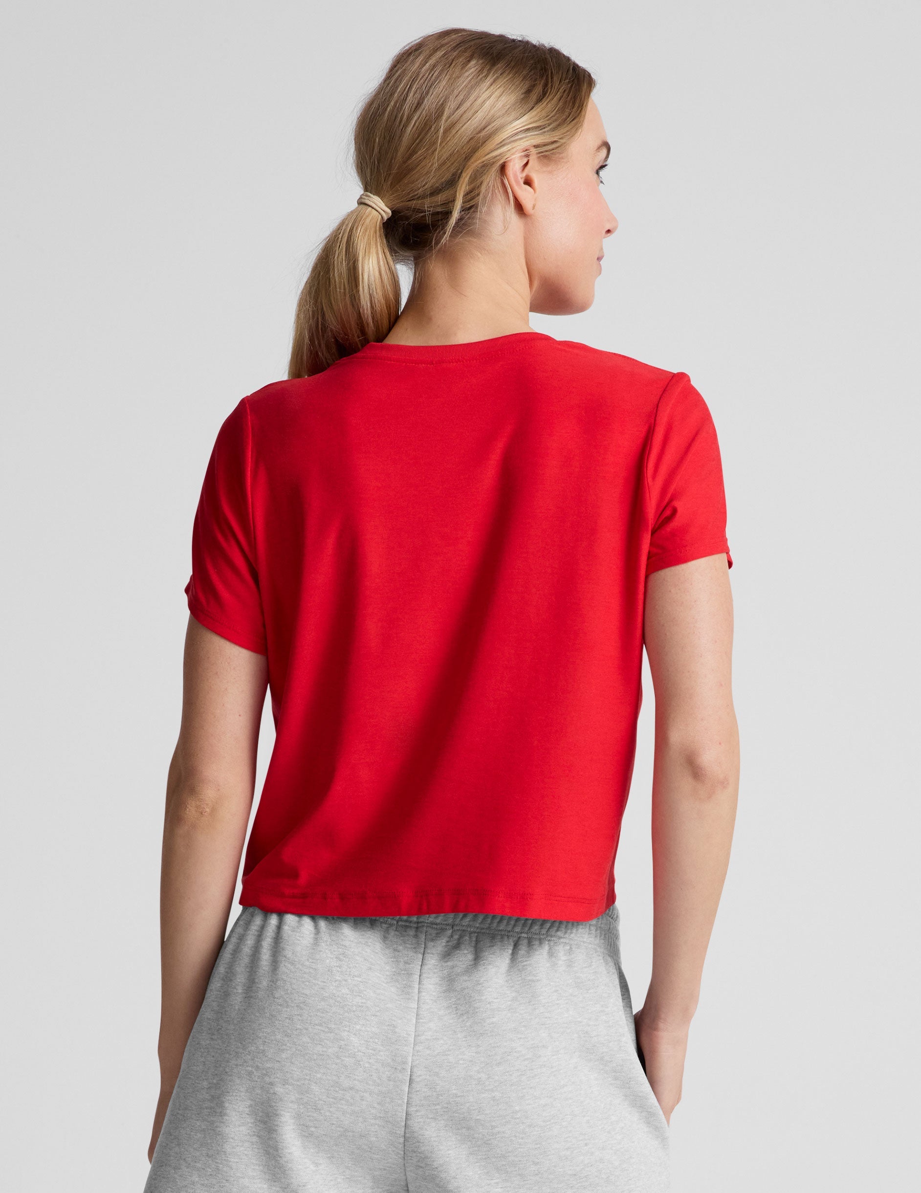red cropped loose-fitting t-shirt with a scooped neckline.