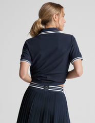 white fitted polo style short sleeve t-shirt with a stripe rib collar and cuff, front placket with buttons, and side slits. 