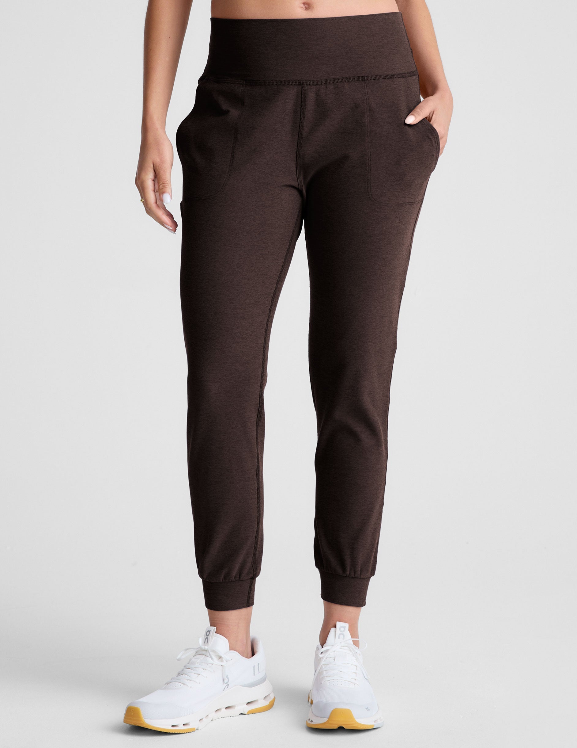 brown high-waisted midi length joggers with pockets.