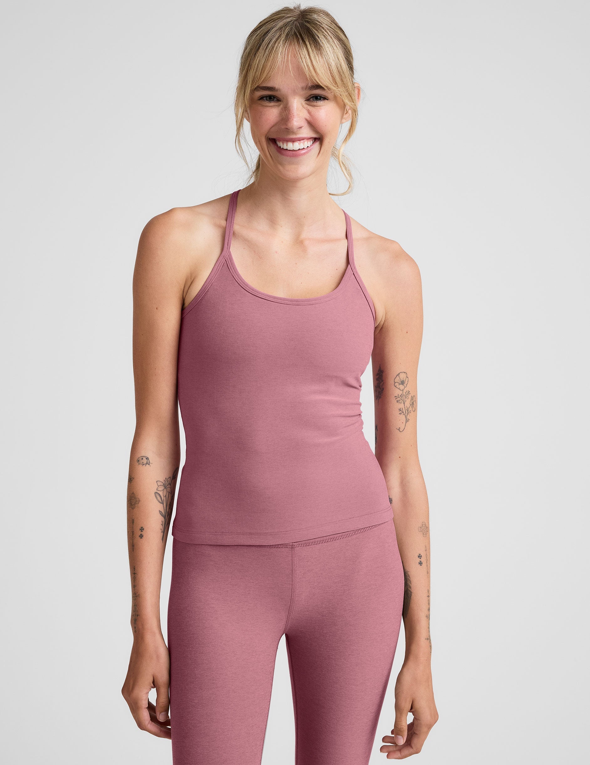 pink waist length racerback tank with slim straps.