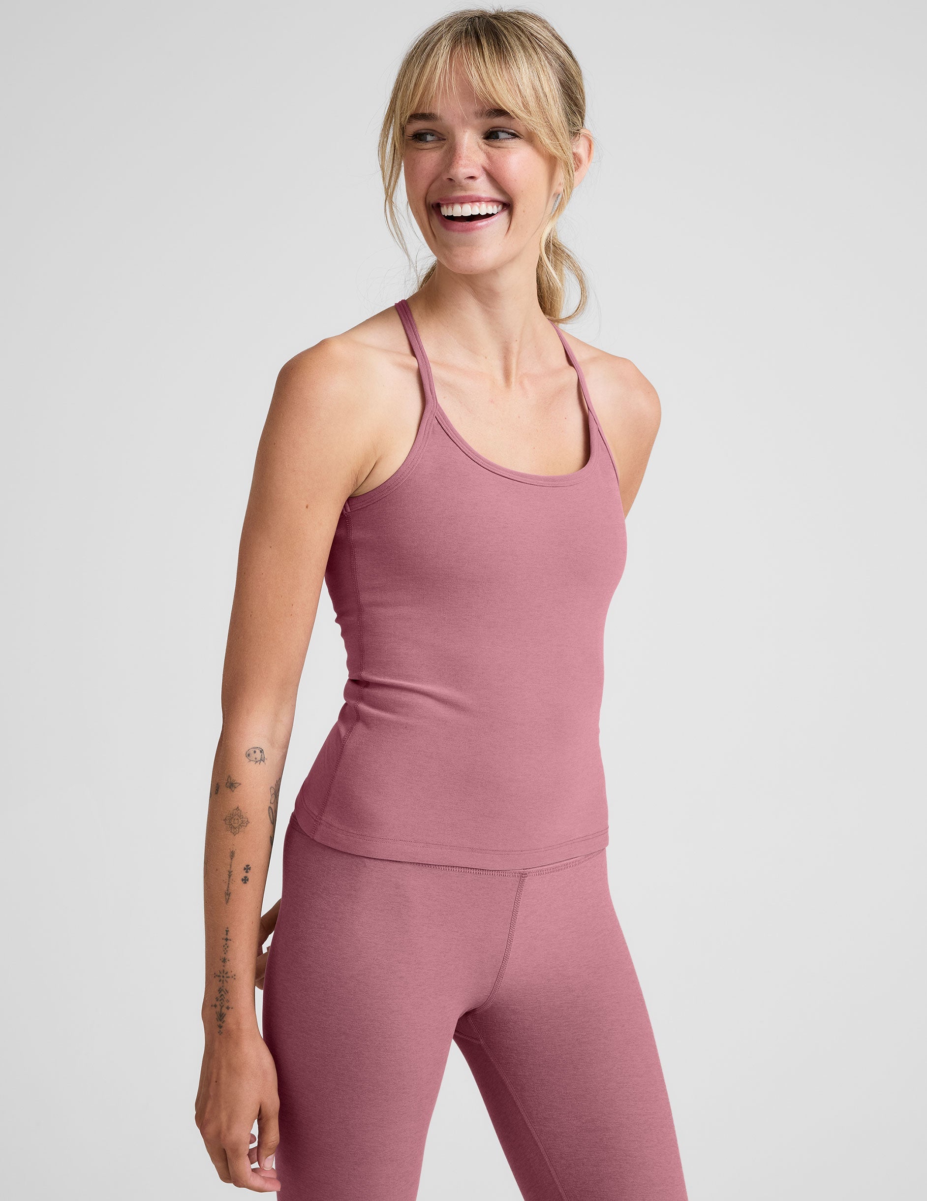 pink waist length racerback tank with slim straps.