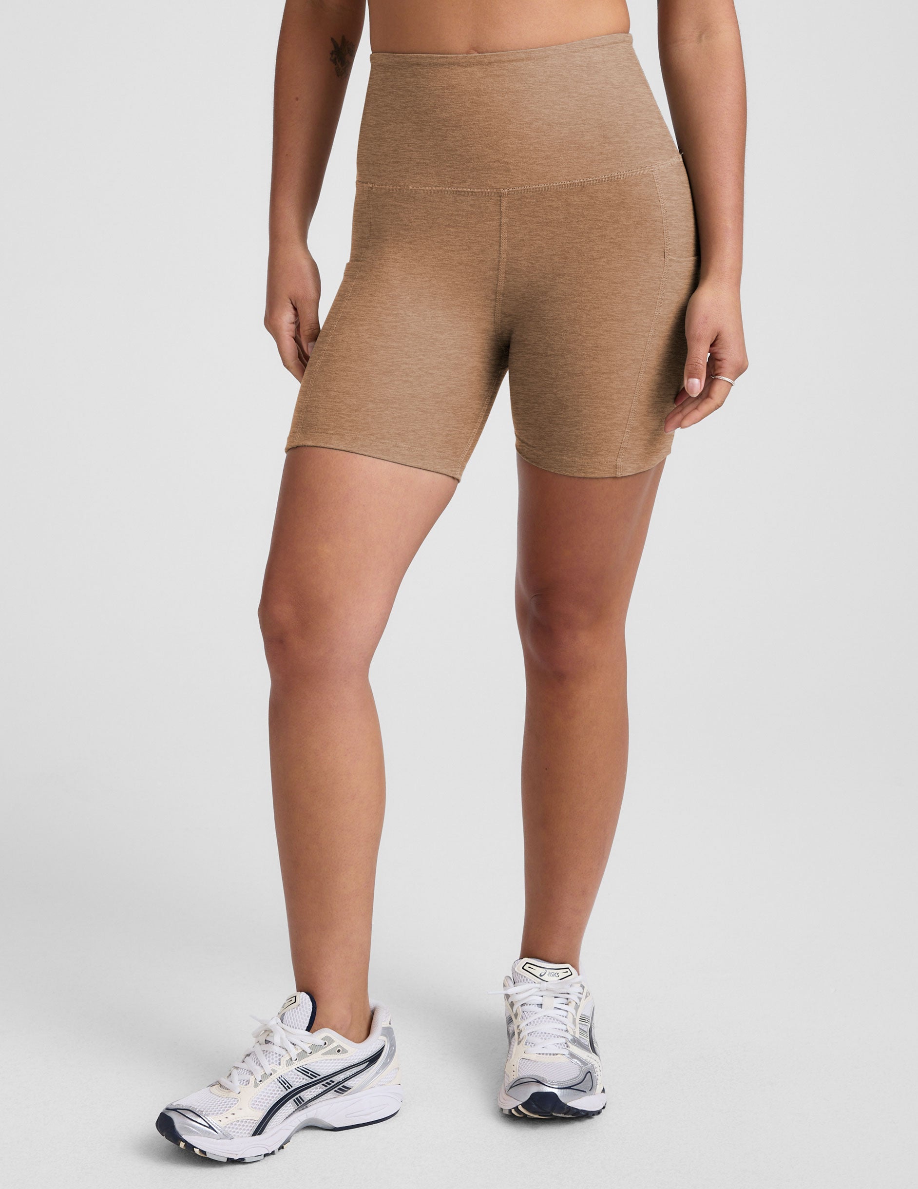 tan high-waisted 5" inseam biker shorts with pockets. 