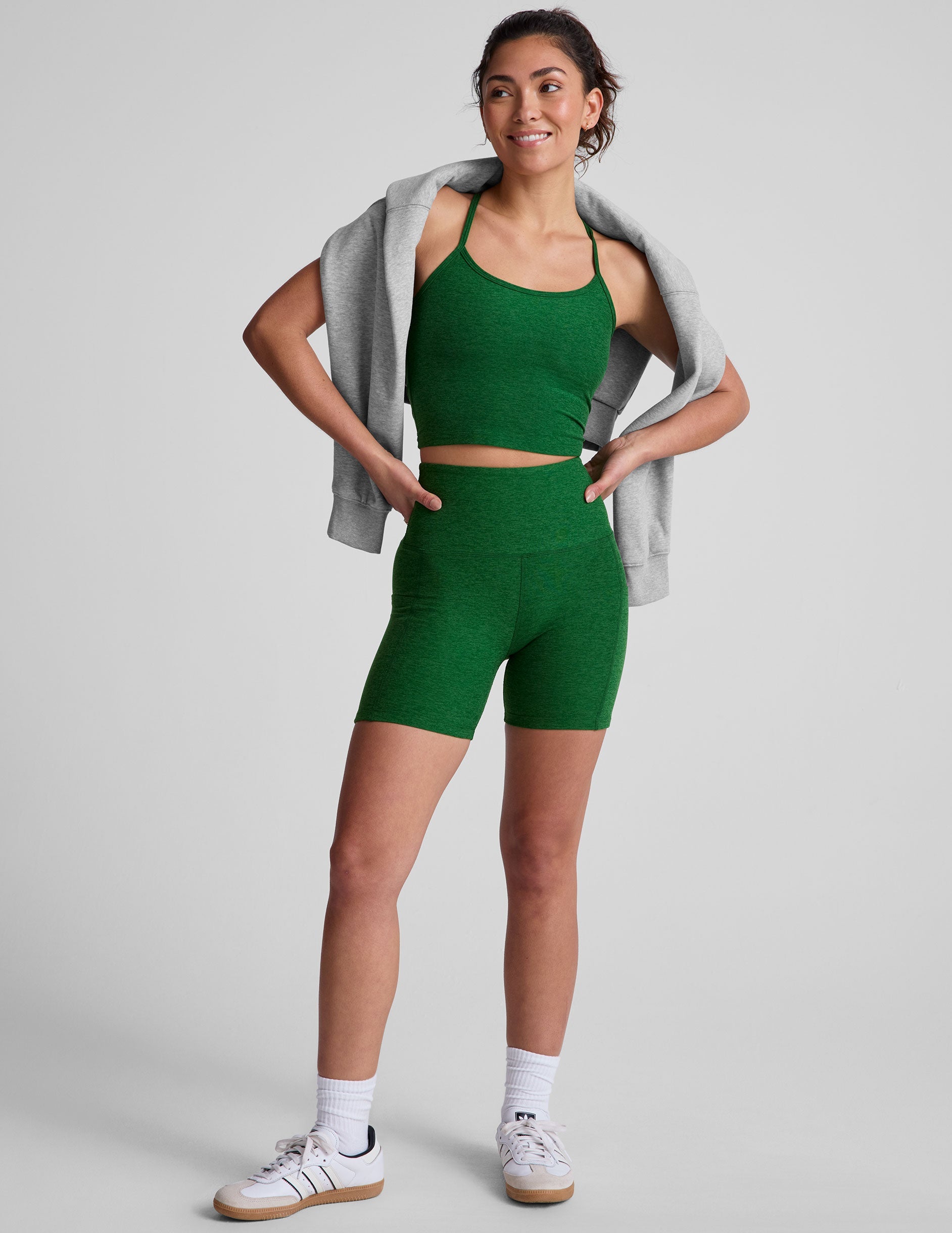 green high-waisted biker shorts with a 5" inseam and side pockets. 