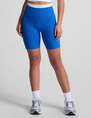 blue high-waisted biker shorts with a 5" inseam, waistband colorblock panels​, and
contrast piping detail on leg​. 
