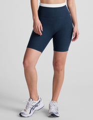 navy blue high-waisted biker shorts with a 5" inseam, waistband colorblock panels​, and contrast piping detail on leg​. 