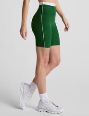 green high-waisted biker shorts with a 7" inseam, waistband colorblock panels​, and contrast piping detail on leg​. 