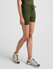 green 5" inseam biker shorts with pockets and a drawcord at waistband. 