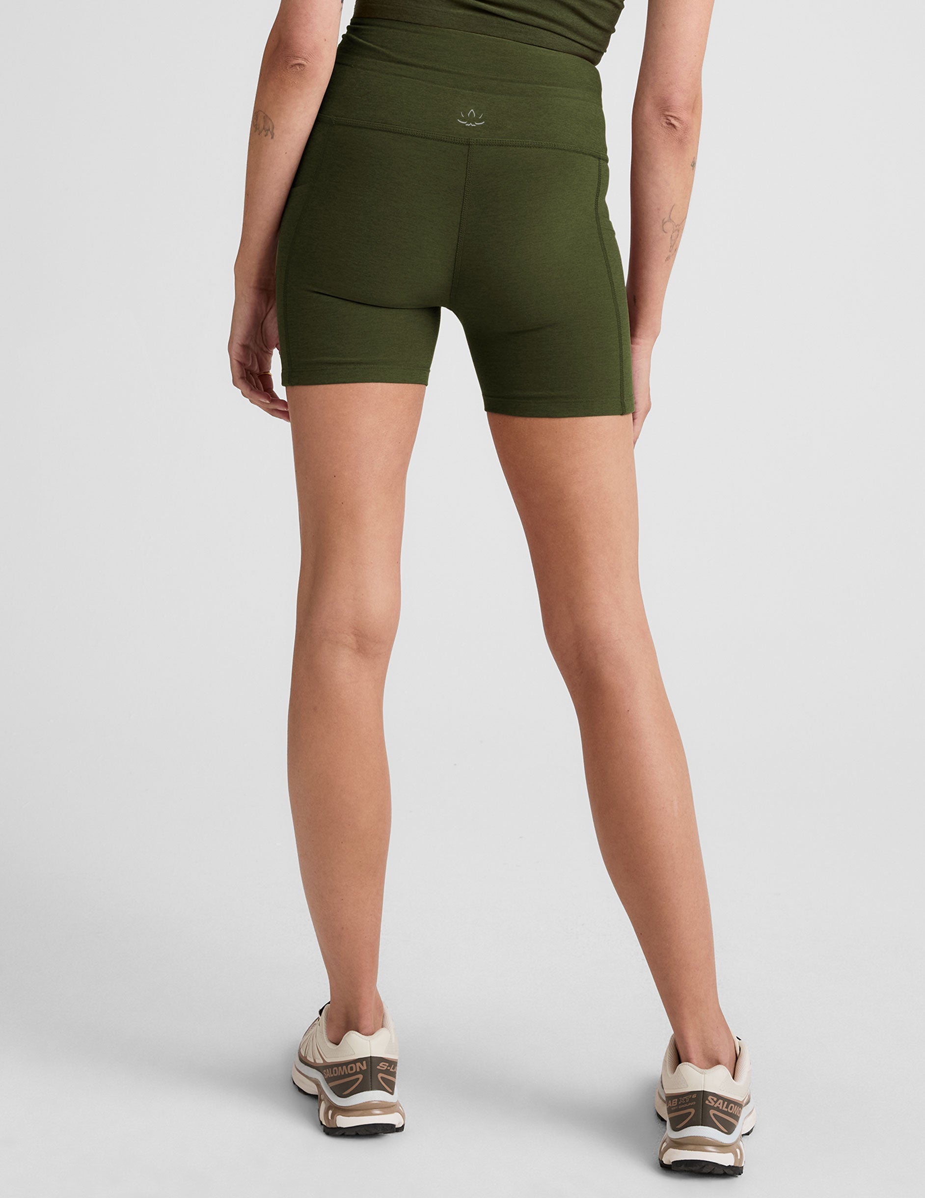 green 5" inseam biker shorts with pockets and a drawcord at waistband. 