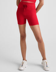red high-waisted 5" biker shorts with pockets and a drawstring at waistband. 