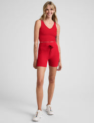 red high-waisted 5" biker shorts with pockets and a drawstring at waistband. 