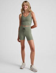 green high-waisted 5" inseam biker shorts with pockets and a drawstring at waistband. 