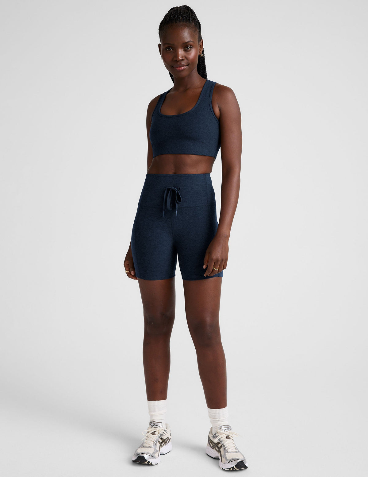 blue high-waisted 5" inseam biker shorts with pockets and a drawstring at waistband. 